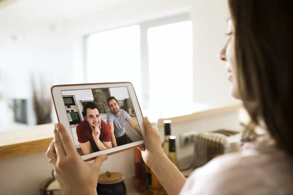 Young woman using tablet for video chat at home